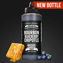 A black bottle of Elijah's Xtreme Bourbon Blueberry Chipotle BBQ Sauce sits next to honeycomb and blueberries. A red “NEW BOTTLE” banner appears at the top right. This award-winning sauce is from the Elijah's Xtreme brand.