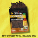 Elijah's Xtreme Pineapple-Mango Habanero Beef Jerky is shown on a yellow background with an Elijah's Xtreme hot sauce bottle beside it and the words “Hint of sweet with a habanero kick,” emphasizing this tropical jerky.