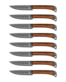 Eight Folded Steel Lotus steak knives, with AUS10 stainless steel blades and brown wooden handles, are aligned in a row on a white background.