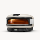 Cream-colored Gozney Arc XL Outdoor Pizza Oven with an arched front opening showing a lit flame and a digital temperature display reading 950 degrees on the base.
