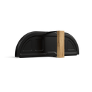 A sleek, black Gozney Dome Gen 2 Door by Gozney, with subtle ridges and a semi-circular metal design, stands upright on a vertical rectangular wooden block against a white background.