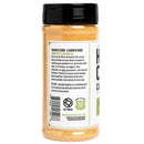 A clear plastic jar with a black lid labeled "Hardcore Carnivore Amplify Mega Savory Flavor Dust Seasoning" contains orange-tan BBQ spice that enhances umami, with usage instructions. Brand: Hardcore Carnivore.