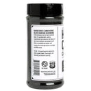 A clear plastic jar with a black lid holds Hardcore Carnivore Black Beef Seasoning—a bold red meat and BBQ rub by Hardcore Carnivore, made with activated charcoal and labeled with ingredients and usage instructions.