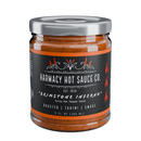 A 9oz jar of Harmacy Hot Sauce Co. Brimstone Inferno Extra Hot Tahini & Roasted Red Pepper Sauce, featuring a bold Mediterranean-inspired blend and a striking black label with fire graphics.