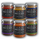 Six jars of Harmacy Hot Sauce Co. The Black Curtain Extra Hot Variety Pack, each with unique labels and fiery sauces made from super-hot peppers—featuring Ox King, Jwala Masala, Wounded Lion, Toetel’s Teeth, Brimstone Inferno, and Tata Del Diablo.