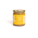 In The Curious Kitchen Bourbon Honey Mustard comes in a glass jar with a gold lid and a yellow-orange label featuring white text and a brief description. Perfect for charcuterie boards, it's shown against a plain white background.