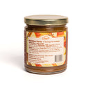 The In The Curious Kitchen Bourbon-Infused Gourmet Gift Set, in a glass jar with a gold lid, features a nutrition facts and ingredients label showing it contains pecans, brown sugar, and Kentucky bourbon against a white background.