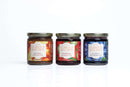 The In The Curious Kitchen Brunch & Breakfast Jam Trio features handcrafted Bourbon Apple Butter, Stiva Berry Jalapeño Jam, and Bourbon Blueberry Jam—perfectly lined up, ready to elevate your Southern-style breakfast.