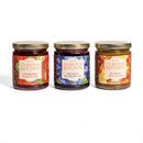 The In The Curious Kitchen Cheese Board Jam Gift Set Trio features Strawberry Jalapeño, Bourbon Blueberry, and Bourbon Apple Butter jams—perfect for cheese or charcuterie boards.
