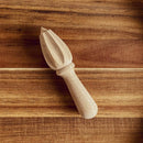 The In The Curious Kitchen Cocktail Bar Tool Kit features a wooden citrus reamer with a grooved, pointed end and rounded handle—an essential tool for home bartenders.