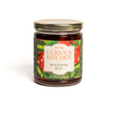 A glass jar labeled "In the Curious Kitchen Entertaining Jam & Jelly Gift Set" by In The Curious Kitchen, with a gold lid and images of green and red peppers, 9 oz (255g), is shown on a white background. Perfect for charcuterie boards.