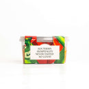 A clear plastic container with a vibrant label featuring vegetables and the text "SOUTHERN HOSPITALITY NEVER TASTED SO GOOD" displays In The Curious Kitchen Jalapeño Pimento Cheese 2-Pack, a tasty Southern-style cheese spread ideal for crackers.