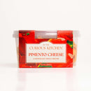 A 2-pack of In The Curious Kitchen Pimento Cheese, a classic Southern spread, features clear plastic containers with red labels reading “Pimento Cheese: A Nostalgic Family Recipe, 10 oz (284g),” set on a white background.