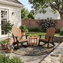 Two Kanyon Living Adirondack Rocking Chair Deluxe in Antique Mahogany & Black face each other on a patio rug, with a small drinks table between them, surrounded by plants, string lights, and a brick wall in the backyard.