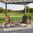 Two Kanyon Living Adirondack Rocking Chair Deluxe seats in Brazilian Walnut & Weathered Wood sit by a small table on a rug under a pergola, overlooking golfers. A potted plant decorates the Kanyon Living patio area.