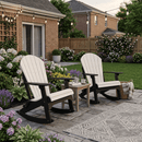 Two Kanyon Living Adirondack Rocking Chairs in Seashell & Black sit on a stone patio among blooming flowers. A small table holds drinks and books, while string lights overhead add to the cozy garden atmosphere.