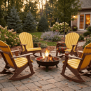 Four Kanyon Living Adirondack Rocking Chairs in Yellow & Cedar Wood by Kanyon Living surround a glowing fire pit on a stone patio. A plaid blanket and mug rest on one chair, creating a cozy scene at sunset with house and trees behind.