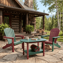 Two Adirondack chairs and a Kanyon Living Poly Lumber Oval Coffee Table in dark green & cherry wood sit on a stone patio by a log cabin. Ferns, mugs, and a blanket decorate the scene as a dog naps nearby, surrounded by trees and mountains.