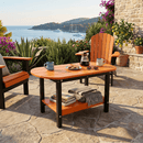 A sunny patio set for breakfast with coffee, pastries, and cups features Kanyon Living’s Poly Lumber Oval Coffee Table in orange & black surrounded by Adirondack chairs, overlooking a sea with sailboats and lush plants.