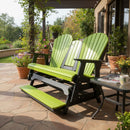 A Kanyon Living Poly Lumber 5′ Adirondack Glider Tall Version in lime green and black sits on a stone patio among potted plants and flowers, next to a small table with magazines and a coffee mug, shaded by a pergola.