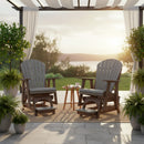 Two Kanyon Living Poly Lumber Adirondack Glider Chairs in tall light grey and weathered wood face each other on a patio with drinks atop a small table, framed by potted plants and curtains, overlooking a lake and trees at sunset.