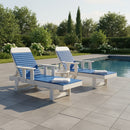 Two Kanyon Living Poly Lumber Chaise Lounges with Arms in Blue and Light Grey sit poolside on a tiled patio, surrounded by greenery. A small table with drinks offers a perfect spot for relaxing between the stylish Kanyon Living chairs.