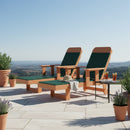 Two Kanyon Living Poly Lumber Chaise Lounges with Arms in Dark Green and Cedar Wood sit on a sunlit patio, ideal for outdoor relaxation. A hat and towel rest on one chair, while a side table with drinks stands nearby amid lush potted plants.