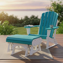 A Kanyon Living Aruba Blue & White Adirondack chair with a Kanyon Living Poly Lumber Gliding Ottoman rests on a deck at sunset, overlooking greenery and water. A book and mug on the armrest invite outdoor relaxation.