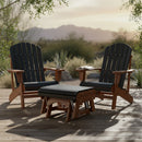 Two Kanyon Living Adirondack chairs with black slats and a matching Kanyon Living Poly Lumber Gliding Ottoman (Black and Deluxe Antique Mahogany) sit on a deck by a mug, book, desert plants, and mountain views under a golden sky.