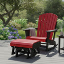 A red and black Kanyon Living Adirondack rocking chair with the Kanyon Living Poly Lumber Gliding Ottoman sits on a gray patio amid greenery and hydrangeas, next to a side table. A light blanket is draped over the chair arm.