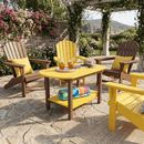 A sunny patio features a Kanyon Living Poly Lumber Oval Coffee Table in Yellow & Cedar, paired with four Adirondack chairs. Colorful towels and drinks rest nearby. Stone flooring, lush greenery, and a pergola frame mountain views in the background.