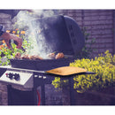 While grilling chicken outdoors with tongs on a gas BBQ, surrounded by garden blooms, a VIGOR Large Insulated Meat Resting Bag sits nearby, ready to keep the grilled meat perfectly juicy.
