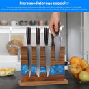 A hand places a knife onto the Norpro Magnetic Knife Block Double-Sided Acacia Wood Knife Holder with Blue Resin, displaying four knives in a modern kitchen. In the background are a fruit bowl and shelves. Blue text reads Increased storage capacity.