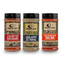 The Mossy Oak Seasoning - Bundle Set of Three by Bourbon Barrel Foods features Country Cajun, Obsession All Purpose, and Bottomland BBQ Rub in clear plastic bottles with black lids—ideal for outdoor cooking adventures.