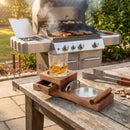 The DDR BBQ Supply Multifunction Cigar & Whiskey Gift Set Stand with Ashtray and Drawer holds a whiskey glass and cigar by the grill, making the perfect patio gift for enthusiasts.