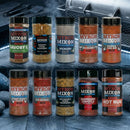 The Ultimate Myron Mixon BBQ Rub 10 Pack features championship seasonings like Savory, Hickory Salt, and Rubba Dub Rub from Myron Mixon, arranged in two rows in front of a smoking barbecue grill.