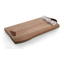 The Napoleon Charcuterie Board (70112) by Napoleon Grills is a rectangular Acacia serving board with a leather handle, featuring three small white ceramic ramekins placed at one end.