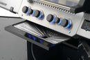 Close-up of a Napoleon Prestige 500V gas grill with five blue-lit control knobs and an open drip tray below fitted with a Napoleon Grills Drip Pan Liner (3 Pack, model 62070).
