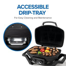 The Napoleon TravelQ PRO285 Portable Gas Grill by Napoleon Grills features open lid cooking for assorted meats and vegetables. Inset highlights the accessible drip tray beneath the grill, making cleaning and maintenance easy. Text: Accessible Drip-Tray.