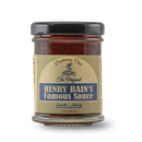 A glass jar of Pendennis Club The Original Henry Bain’s Sauce by Bourbon Barrel Foods, with a beige and blue label, is shown on a plain white background.