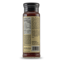The back of a glass bottle of Pendennis Club The Original Henry Bain’s Sauce by Bourbon Barrel Foods displays nutrition facts, the sauce’s club origins, ingredients, barcode, and distributor info on a beige label.