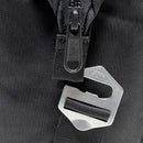Close-up of a black Polar Bear Coolers 12 Pack Original Nylon Soft Cooler with a visible zipper and a metal multi-tool attached, featuring a keyhole and engraved bear outline.