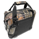 The Polar Bear Coolers 12 Pack Original Nylon Soft Cooler features a camouflage pattern, black straps, side buckles, and a padded handle. The insulated soft cooler is shown angled on a white background.