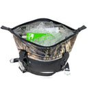 The Polar Bear Coolers 12 Pack Original Nylon Soft Cooler, in a camo pattern, is open with ice and a green can inside. It features black handles and a zippered top—ideal for keeping drinks cold.