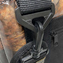 Close-up of a black plastic carabiner clip on a black strap of the Polar Bear Coolers 12 Pack Original Nylon Soft Cooler, with a clear panel displaying brown coffee beans inside the insulated bag.