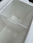Get a close-up look inside the Polar Bear 20 Hard Cooler by Polar Bear Coolers, highlighting its removable divider and small drainage hole at the bottom.