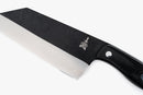 A close-up of the Folded Steel Primrose Cleaver with a 1095 high-carbon steel black blade, engraved logo by the handle, and a textured black handle with metal rivet—ideal for outdoor cooking, shown on a white background.