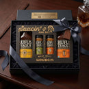 The Rufus Teague Saucin' & Rubbin' BBQ Gift Set comes in a black-ribbon box and includes two barbecue sauces plus Honey Sweet, Touch O Heat, Spicy Meat Rub, and Steak Rub spice jars from Rufus Teague.