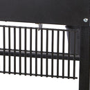 Close-up of the black metal grate on the Smokin Brothers “30” Premier Plus Pellet Grill, with a screw in the upper right corner and part of a bucket visible in the background.