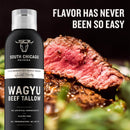 A can of South Chicago Packing Wagyu Beef Tallow Cooking Spray is shown beside juicy sliced steak, with "Flavor has never been so easy" in bold white letters above—perfect for nonstick cooking.